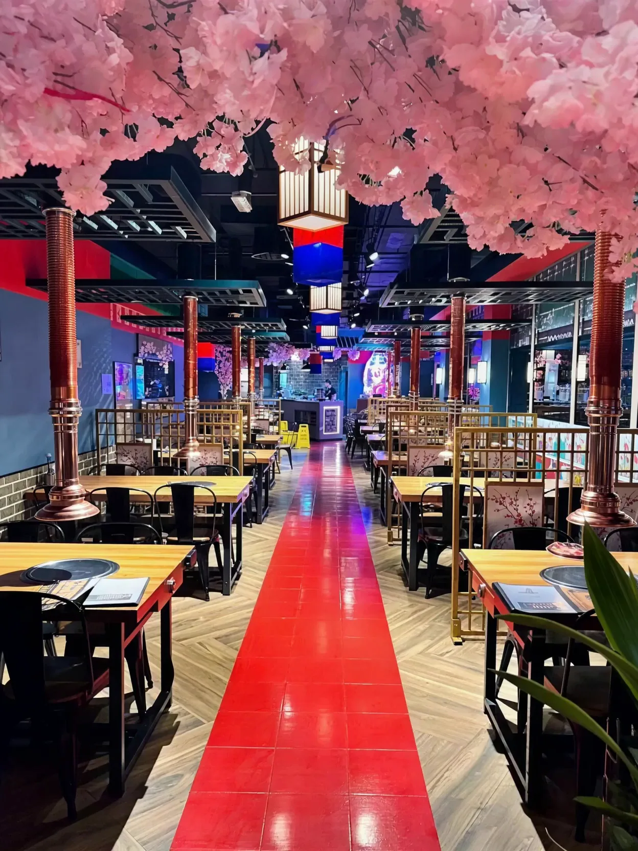 Neon-lit cherry blossom dining hall at Mukbang Shows JBR